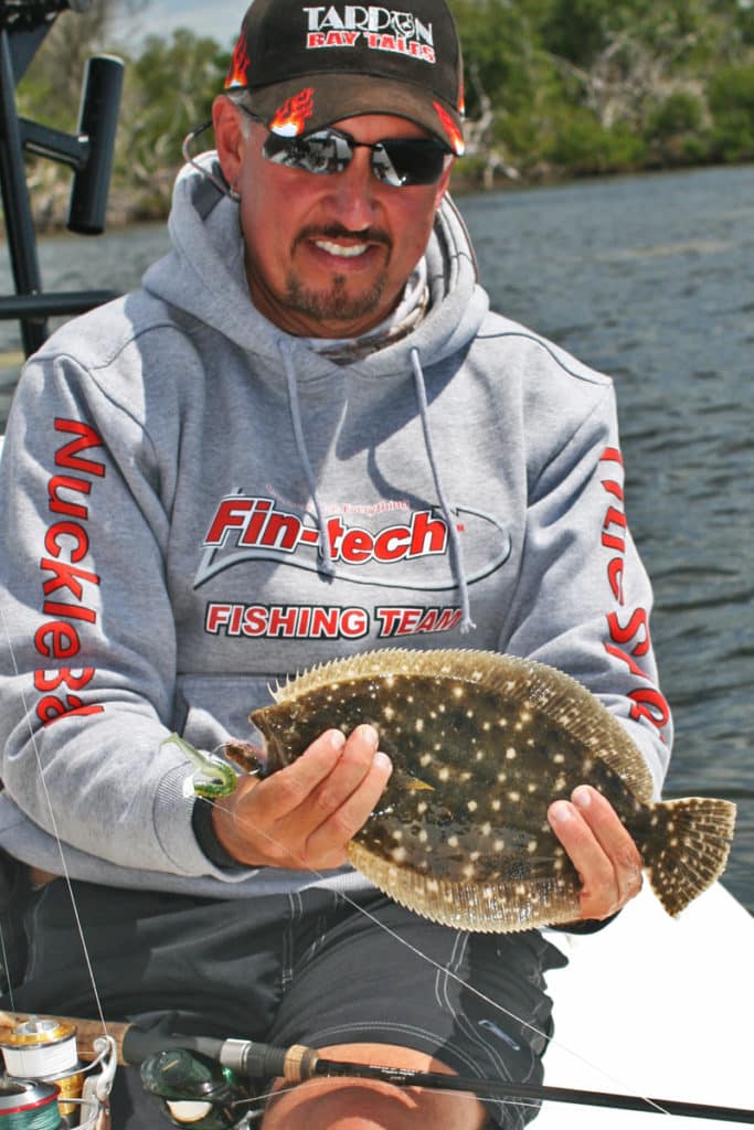A flounder caught on a jig and a soft-plastic lure.
