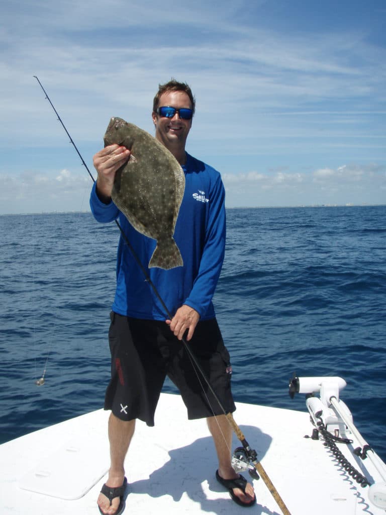 Fisherman displays a nice flounder.